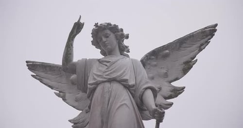 Funeral, cemetery and angel on tombstone for death ceremony, religion or memorial service