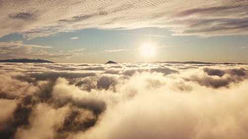 Golden Morning Sun Shining Brightly Above A Thick Sea Of Clouds