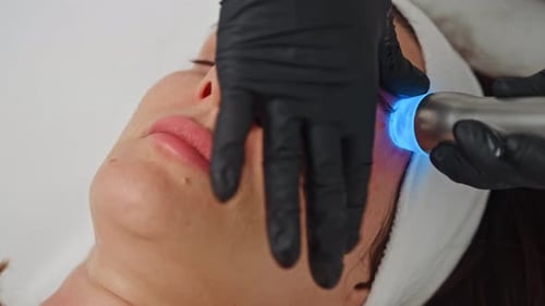 Woman Receiving Blue Light Facial Treatment Close Up