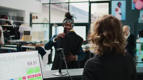 African American Shopper Buying an Elegant Suit Jacket From Clothing Store