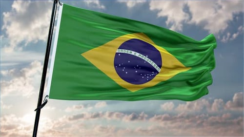 Brazilian Flag Waving Against Cloudy Sky with Sun Flare