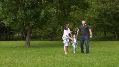 Happy Family with Daughter on Park