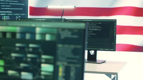 Computer Monitors with Programming Code and American Flag