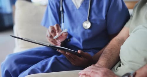 Healthcare Worker Taking Notes for Patient