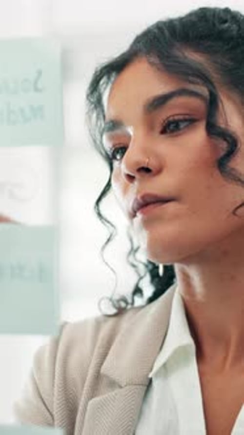 Woman Writing on Board in Office Setting