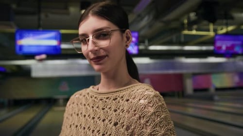 Portrait of Middle Eastern Girl with Bowling Ball on Alley