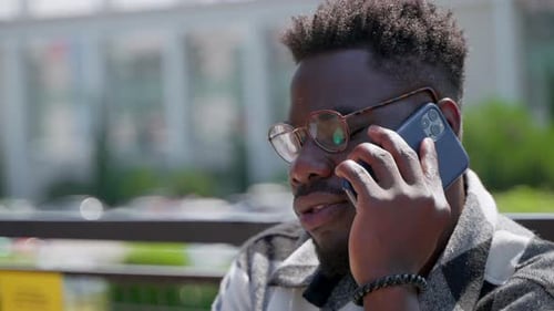 African American Man Talking on Mobile Outdoors in the City