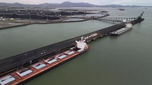 Aerial view of Gladstone coal terminal pier with freighters moored