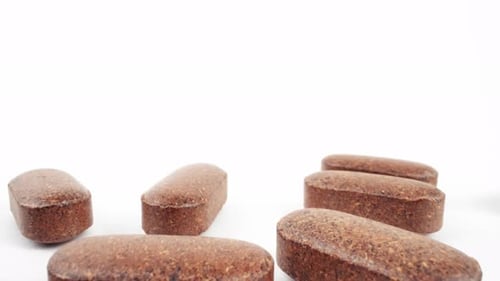 Brown Supplements on White Surface