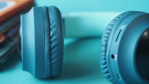 Blue Wireless Headphones Close Up on Blue Surface
