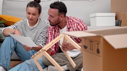 Couple Building Furniture Together in Home Surroundings