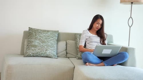 Young Adult Woman Using Laptop on Couch