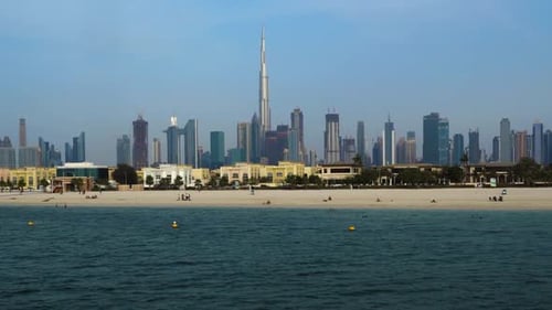 Panoramic View Of Burj Khalifa Tower And Dubai Skyline From Beach Side In Dubai, UAE. wide panning s