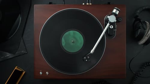 Vinyl Record Spinning in Slow Motion on a Stylish Turntable Standing on a Table - Top View.