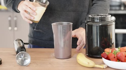 Person Preparing Healthy Smoothie at Home