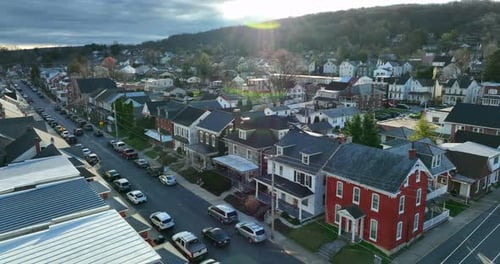 Aerial of homes in small town in USA during winter dramatic light. Beautiful colorful shot.