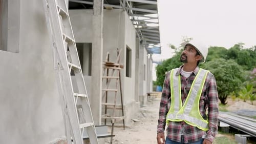 Construction Worker Inspecting New Building Project