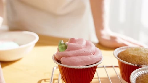 Cupcake being Decorated with Gummy Candies