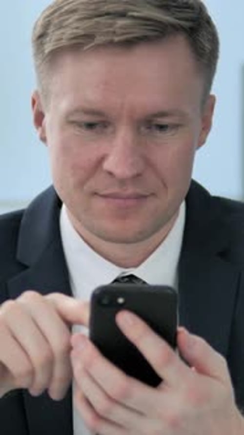 Business Man in Suit Using Mobile Phone