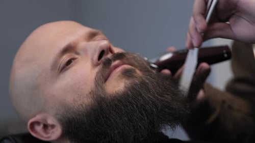 Bearded Man Receiving Beard Trim at Barber Shop