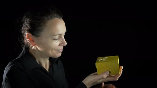 Woman Looks Into Gift Box, Opens Box