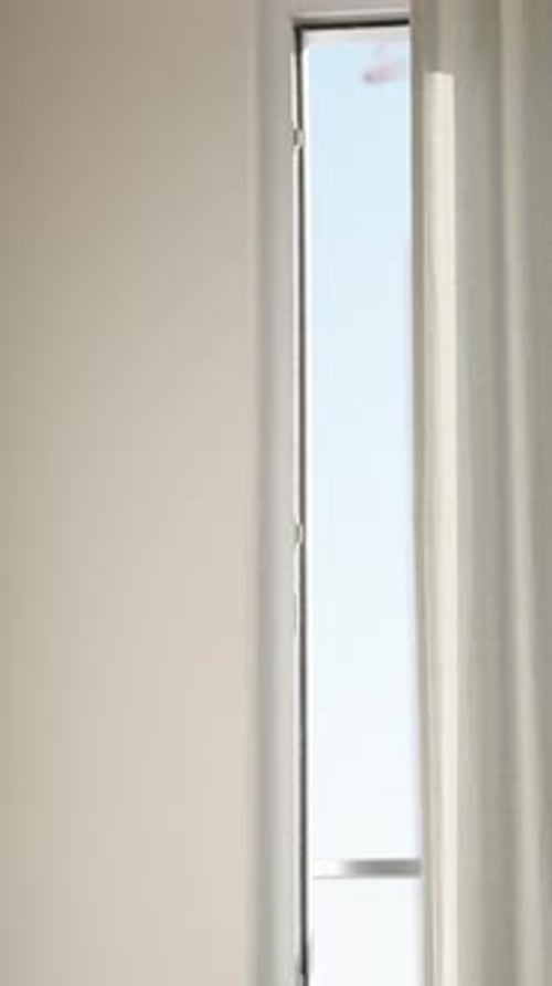 Bright Window with Pale Curtain and White Wall