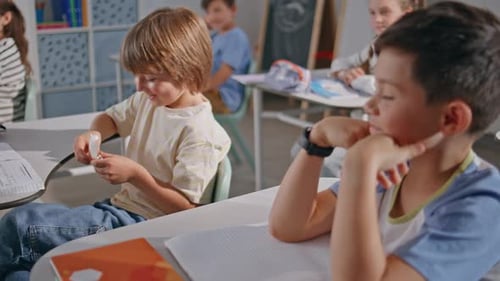 Two Boys Talking Lesson at School Closeup Funny Child Reading Note Classmate