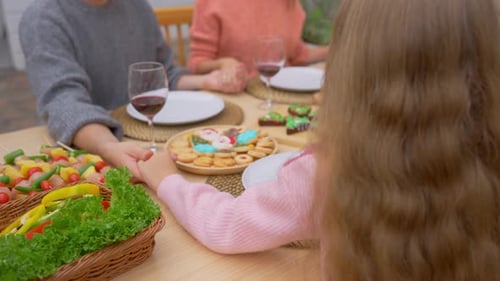 Close up of lovely family saying a prayer before having dinner party.
