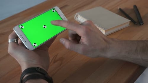One Businessman Use the Handheld Cellphone with Greenscreen Touchpad and Gesturing Close