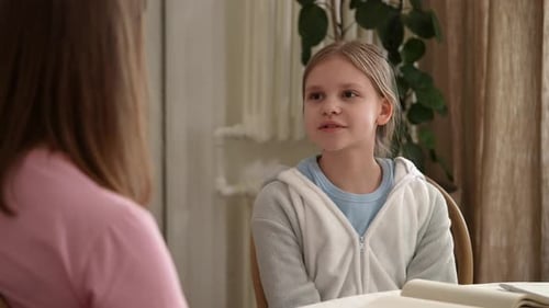 White Girl Speaking to Mother at Table Confident Expression and Steady Gaze Open Conversation About
