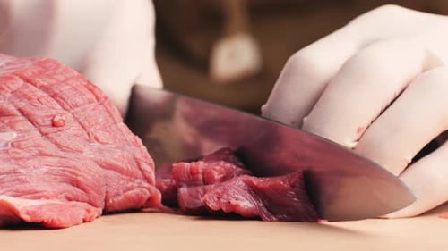Close Up: Cutting Raw Beef Meat with Knife