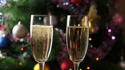 Festive Champagne Glasses in Front of Christmas Tree