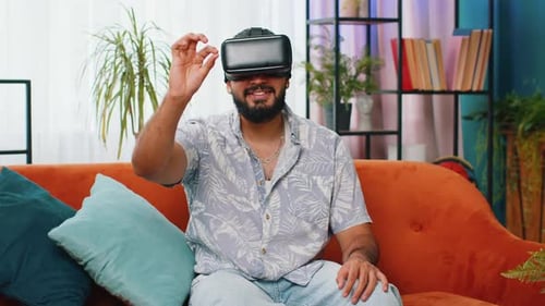 Man Immersed in Virtual Reality Experience on Couch