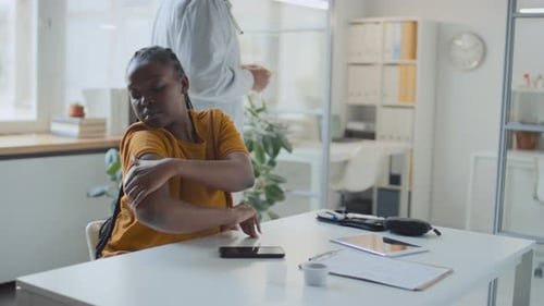 Doctor Applying Sensor Device to Patient's Arm