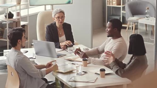 Businesswoman Having Office Meeting with Team