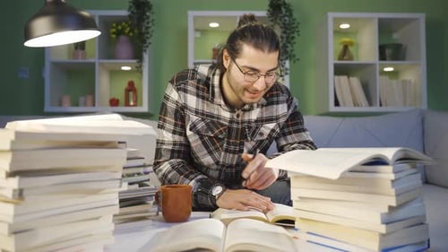 College student male happily studying at home.