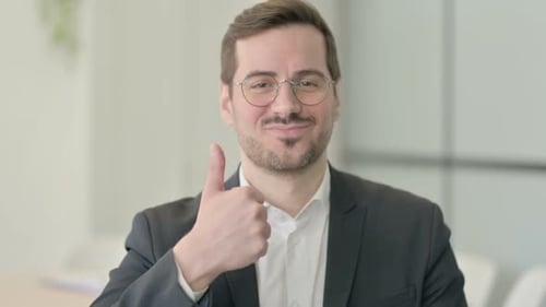 Man in Suit Gives Thumbs Up of Approval