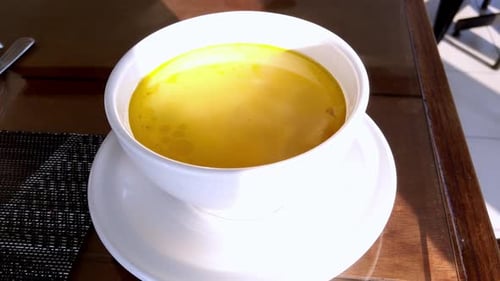 Bowl of Delicious Yellow Soup on a Table
