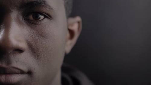 Close up of Young Man Opening His Eyes