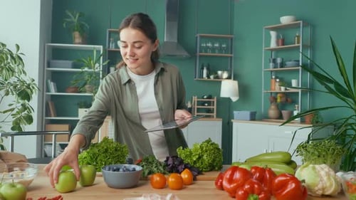 Woman with Tablet Surrounded by Fresh Vegetables