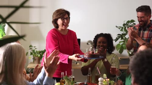 Friends Celebrate Birthday Party with Cake and Candles