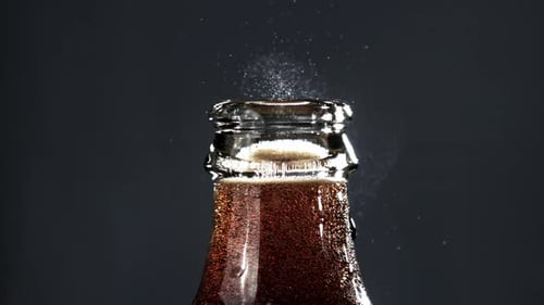 Eine offene Flasche Cola, gefilmt mit einer Hochgeschwindigkeitskamera mit 1000 Bildern pro Sekunde