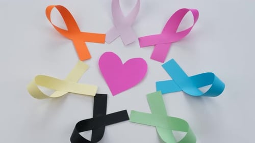 Heart and Colorful Paper Ribbons on White Surface