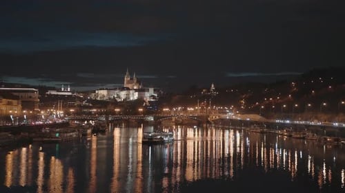 Night view of Prague from Stefanik Bridge, river, illuminated castle, and boats