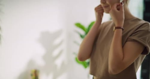 Happy women admiring earrings in fashionable boutique clothing store
