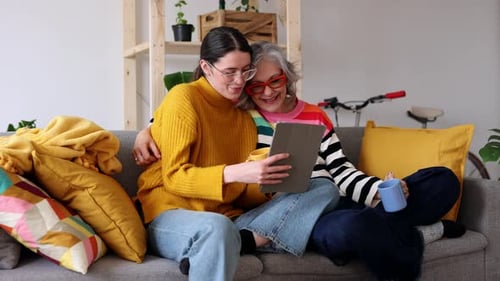 Young Woman and Senior Woman Looking at Tablet