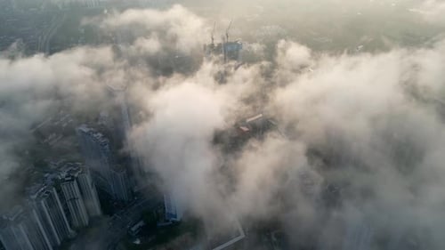 Aerial perspective morning light low fog clouds majestic Kuala Lumpur skyline.
