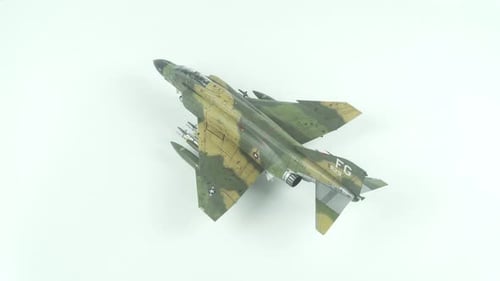 Overhead shot of military jet model on white