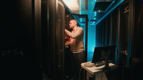 Man Working Inside Data Center Server Room
