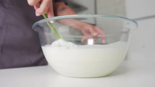 Woman Baker Mixing White Vanilla Cream in the Glass Bowl